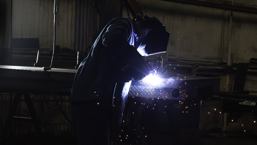Someone welding a steel part
