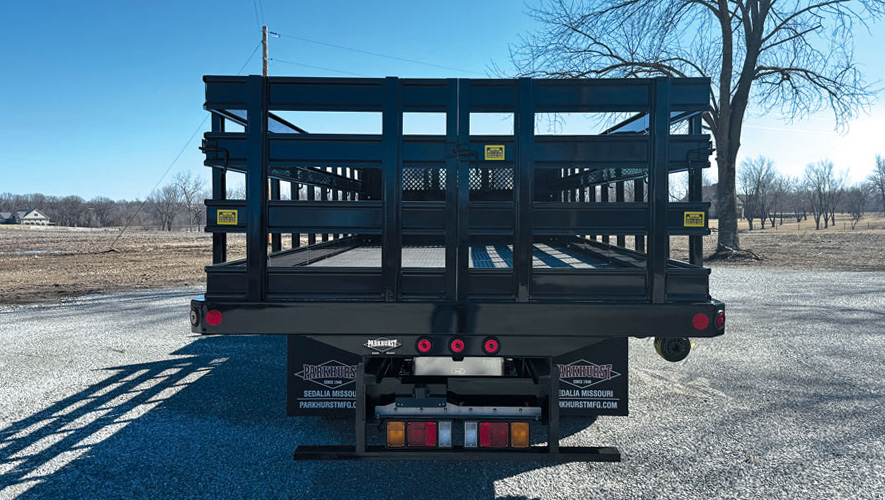 A rear view of a Parkhurst work truck body with steel stake racks
