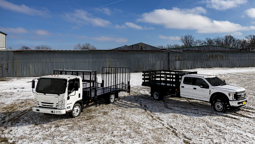 Two Parkhurst work trucks parked in a snowy field