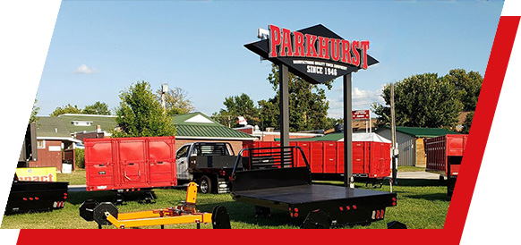 The Parkhurst sign outdoors surrounded by truck bodies for display