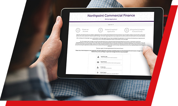 A man holding a tablet and reviewing a distributor financing form