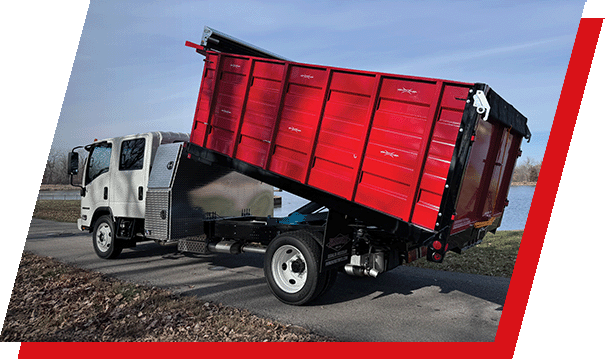 The Parkhurst Toughline Platform truck body with a tilted bed in front of a pond