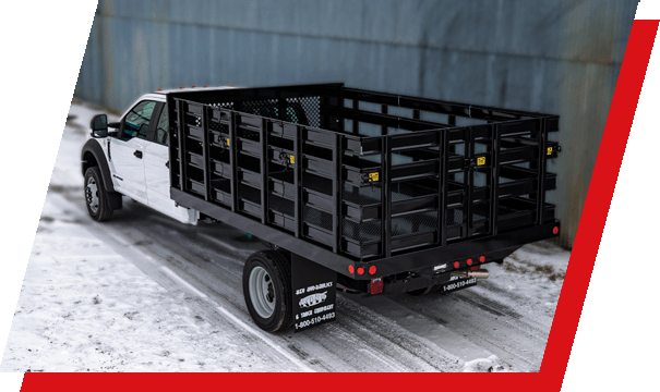 Side view of a truck with stake racks in winter